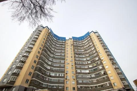 Windows of multi-storey tall building against background of sky Stock Photos