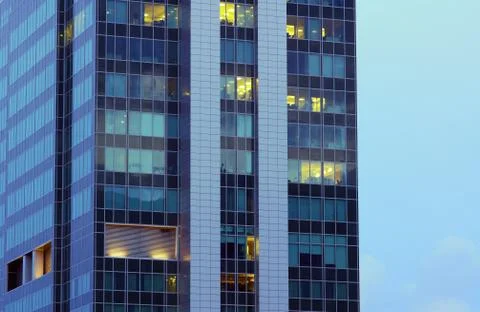 The windows of an office building in the evening Stock Photos