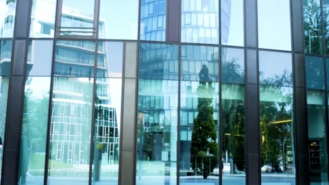 The windows of the office reflect the windows of the neighboring office and Video stock 137751659