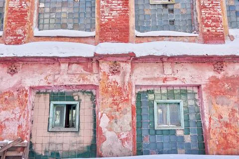 The windows in the old brick wall of an abandoned industrial building. Stock Photos