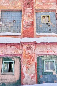 The windows in the old brick wall of an abandoned industrial building. Stock Photos
