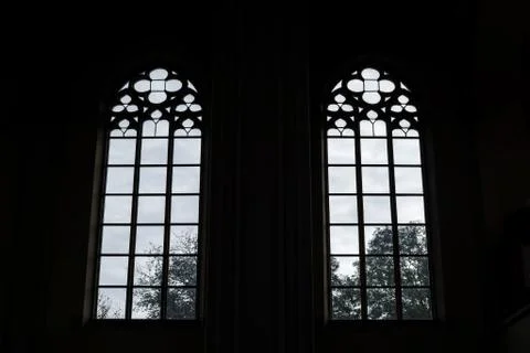 Windows of an old building from the inside. Outside the windows the sky and t Stock Photos