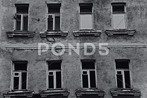 The windows of the old dilapidated city buildings Stock Photos