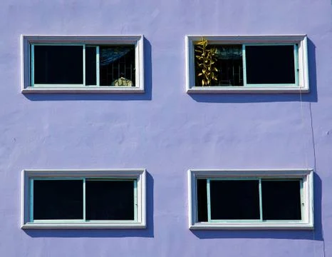 Windows on the purple wall. Stock Photos