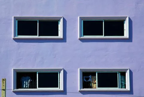 Windows on the purple wall. Stock Photos