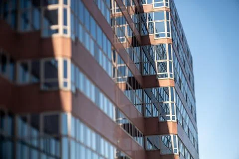 Windows of a red office building. Stock Photos