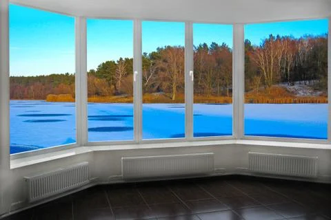 Windows of room overlooking winter river. Panorama with winter frozen lake Stock Photos