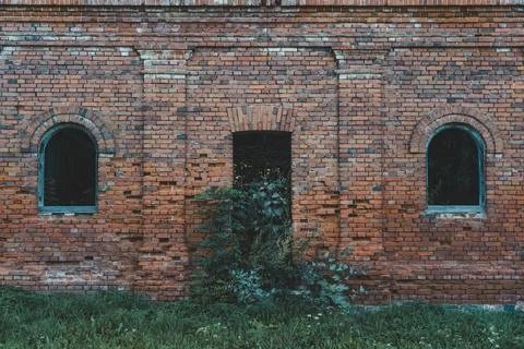 The windows of a ruined brick stable. 19th century buildings Stock Photos