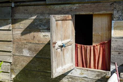 Windows of a rustic shack house made from wooden planks and plywood Stock Photos