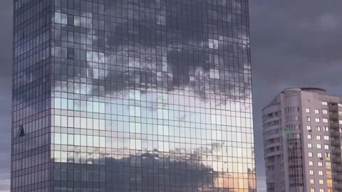 The Windows of the skyscraper reflect the evening sky with clouds.Urban landscap Stock Footage 136696699