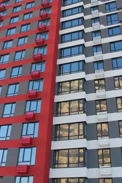 Windows of Smart Flats On Multi Colored High Rising Apartment House Stock Photos