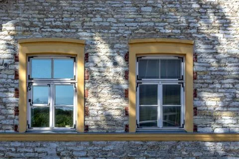 Windows on a stone wall. Stock Photos