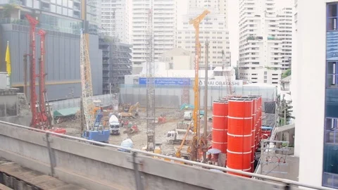Windows view of BTS Skytrain arriving at Nana station with passengers waiting Stock-Footage 115960849