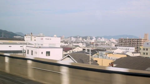 Windows view of Shinkansen high speed train speeding through city 스톡 동영상 113383086