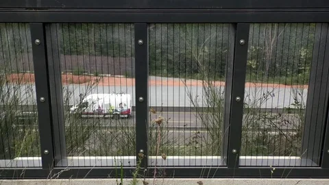 Windows in a wall next to German motorway (autobahn), Kaiserslautern, traffic Stock Footage 80273615