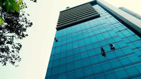Windows washers cleaning office windows at a high building Stock Footage 108709190