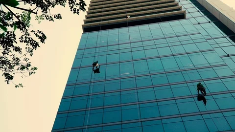 Windows washers cleaning office windows at a high building Stock Footage 108711499