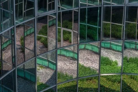 The windows in which the courtyard is reflected Stock Photos