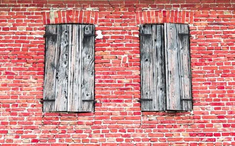 Windows with wooden frames on brick wall. Stock Photos