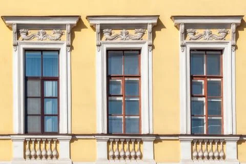 Windows on the yellow wall. Stock Photos
