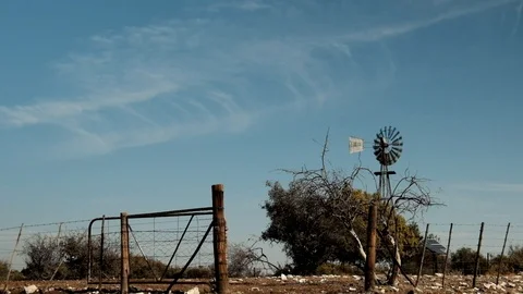 Windpump windmill old farmgate and clouds pumping water Stock Footage 112531944