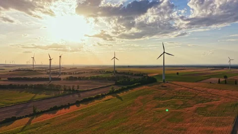 Winds of change turn in a field with wind turbines under a setting sun in the Stock Footage 344142300