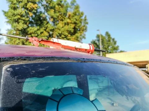 Windscreen is being replacing and silicone bottle is kept on the roof top Stock Photos
