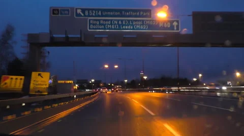Windscreen view, Manchester ring road M60 by Trafford at night Stock Footage 61048578