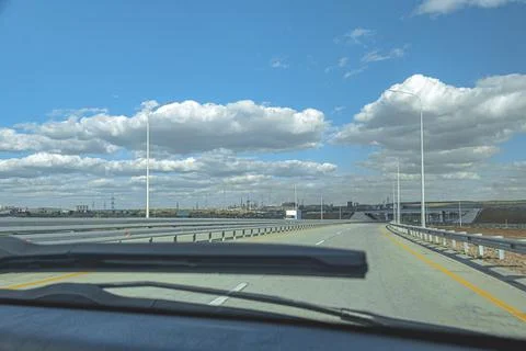 Windscreen view of road, sky and in a spring, summer or autumn day Stock Photos