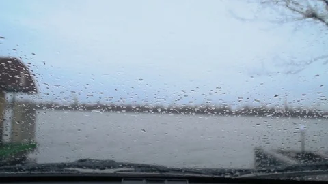 The windscreen wiper on the car clean the rain from the glass Stock Footage