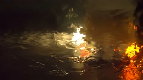 Windscreen wiper removing rain from windshield at night Video stock 121153596