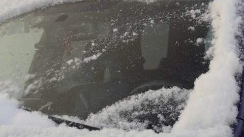 Windscreen Wipers brushing away the snow from a car's windshield Stock-Footage 73659844