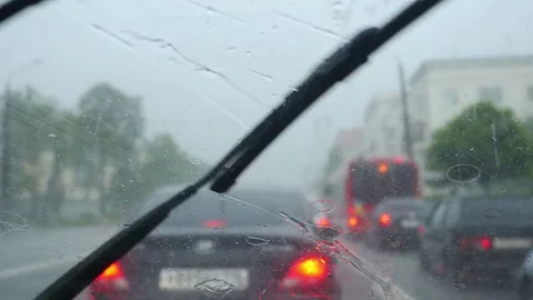 Windscreen wipers cleaning windshield glass on deep rainy day. 3840x2160 Stock-Footage 80411750