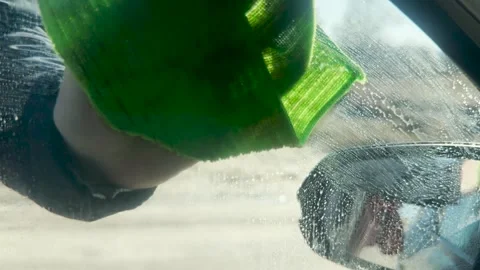 Windshield detailing in progress, precise hand motion cleaning, reflections Stock Footage 307773047