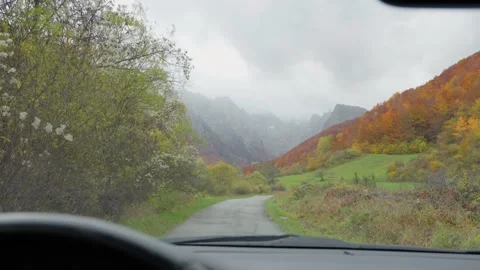 Windshield drive toward misty mountain gorge in Montenegro in fall Stock Footage 329412358