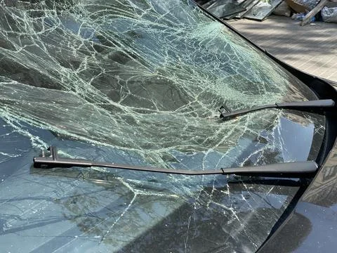 Windshield Has Broken. The windshield of the car was shattered after the war. Stock Photos