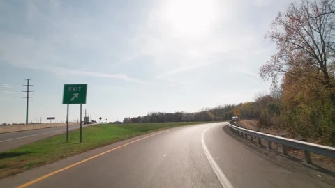 Windshield perspective of car exiting through curved roadway in Ohio Stock Footage 295312688