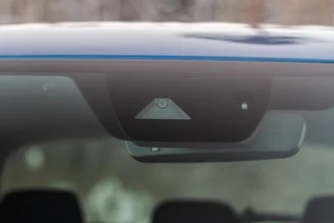 Windshield rain and light sensors of modern car. Car rain sensor. Stock Photos