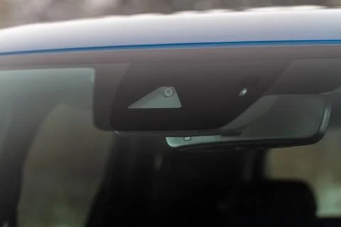 Windshield rain and light sensors of modern car. Car rain sensor. Stock Photos