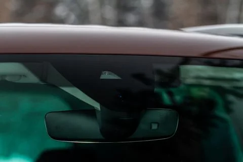 Windshield rain and light sensors of modern car. Car rain sensor. Stock Photos