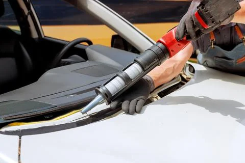 Windshield replacement process in action on works day at an auto repair shop Stock Photos
