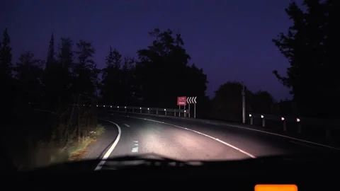 Windshield road view of moving car on street at dusk Stock Footage 133376098