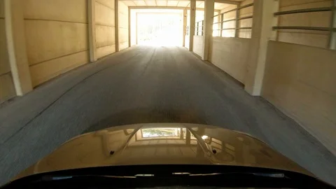 Windshield view of car driving out from small tunnel Stock Footage 117727674
