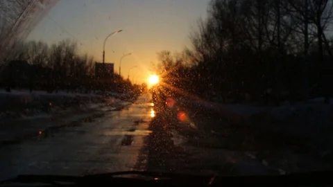 Windshield view of sunset at the city road, beautiful lens flare Stock Footage 74434156