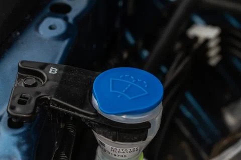 Windshield washer fluid reservoir cap. Windshield washer liquid cap inside a  Stock Photos