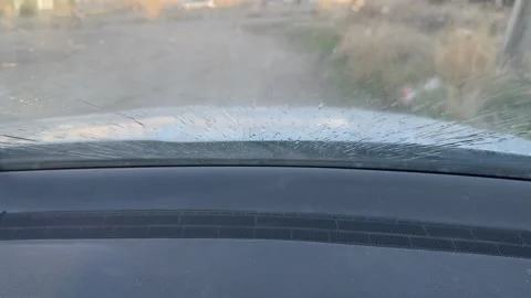 Windshield washer sprays water while wipers clean the front glass from an Stock Footage 337114590