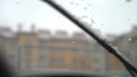 Windshield wiper blades clear snow from windshield in winter in slow motion Stock-Footage 146343025