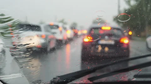 Windshield wiper cleaning during storm while driving on streets. Stock Footage 295775118