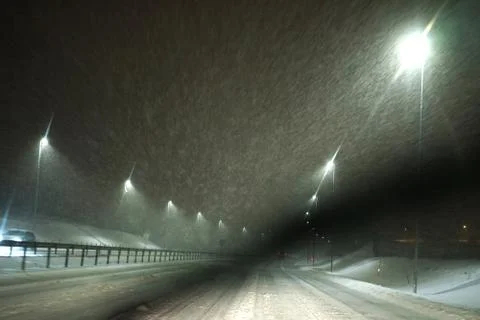 Windshield wiper from the inside of the car in working state while snowing. Stock Photos