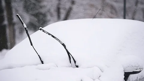 Windshield wiper of an snow covered car after heavy snowfall Video stock 71277996